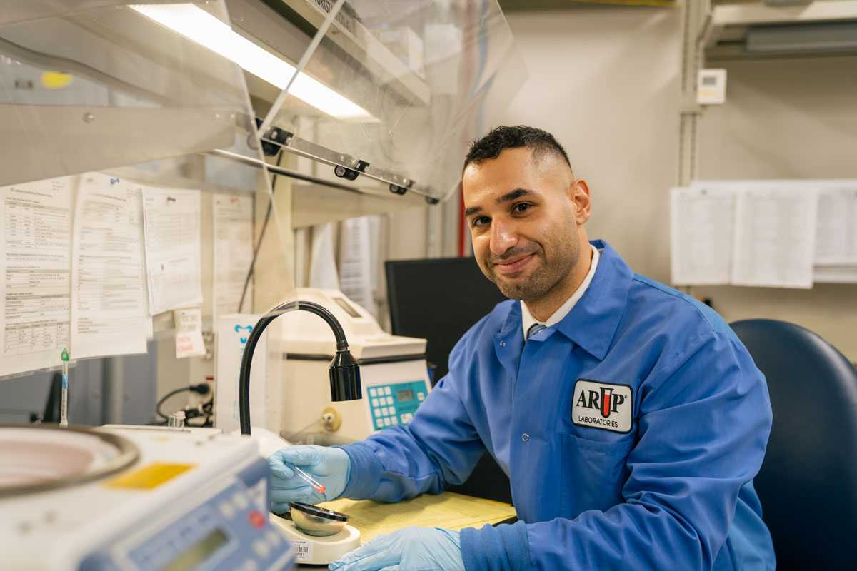 Waseem Anani smiles to the camera as he works